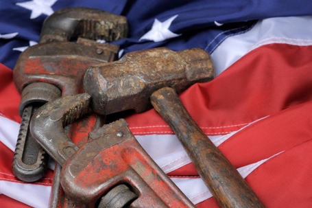 Rusty tools laying on an American flag