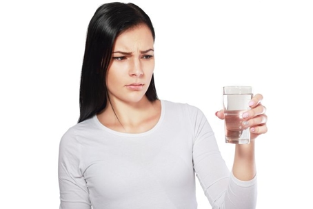 Woman holding glass of water