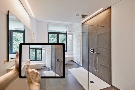 person taking a picture of their bathroom with an iPad