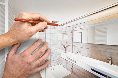 Man sketching out a bathroom remodel plan