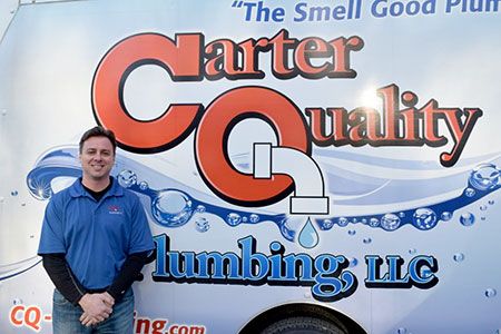 Fort Mill plumber standing in front of Carter Quality Plumbing LLC truck